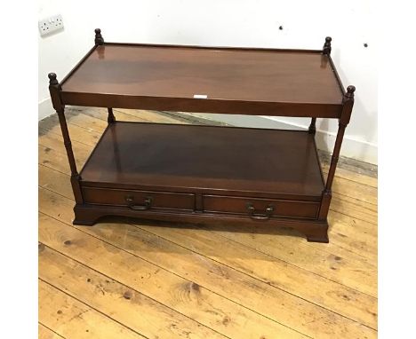 A reproduction two tier table, the rectangular top with shallow gallery and finial to each corner, above an open shelf and tw