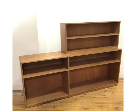 A 1970s wooden open bookcase of asymmetrical form, the raised back enclosing a single shelf, with four further compartments b