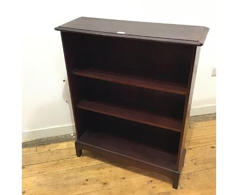 A Stag open bookshelf, the rectangular top with moulded edge and rounded front corners above two shelves, raised on bracket f