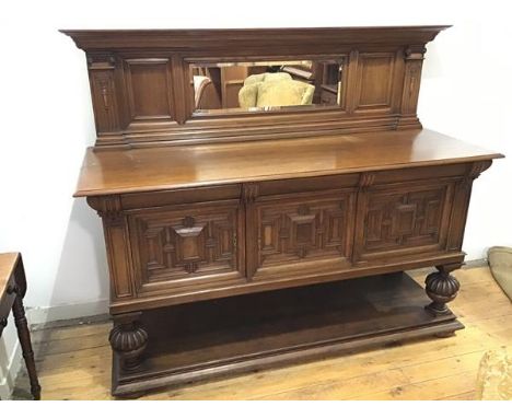 An oak Edwardian sideboard, the upper tier of back on moulded frieze supported by two Ionic pilasters, enclosing two panels w