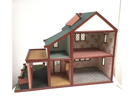 A 1970s doll's house complete with wallpapered interior, carpet, hanging cupboard, mirror, bed warming pan, wall sconce and l