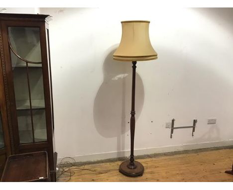 A mid 20thc floor lamp, with turned stem on circular base, with bun feet (height with shade: 183cm. base:d. 32cm)
