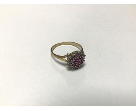 A 9ct gold ruby and diamond cluster ring set eight rubies with surround of eighteen diamonds (O/N) (2.1g)