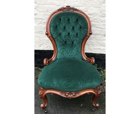 A good quality 19thC carved walnut nursing chair with button back up upholstery casters. 