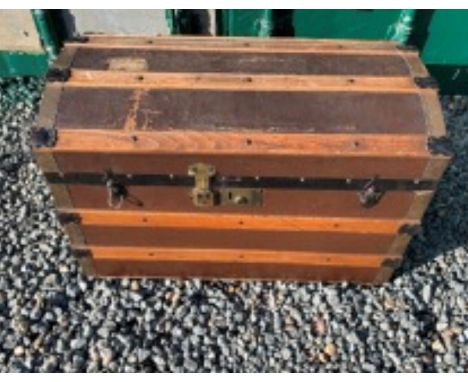 A dome topped trunk with wooden bands to top. 
