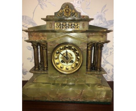 Mantle clock in onyx case with brass pillars. Paris made. Onyx slight a/f at one side. 35cms h.