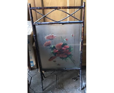 A 19thC bamboo firescreen with floral painting. 