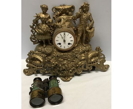 Decorative gilt metal mantle clock with figures, finial a/f together with a pair of small brass binoculars. 