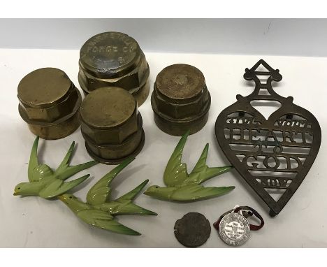 Four brass tractor hubs, 3 flying metal birds, a brass trivet and 2 medals including Kirstall, Forge Co Leeds.