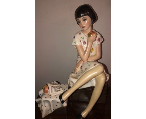 A Lenci figure of a young girl seated with a book eating an apple. '' DOPO LO STUDIO'' Abel Jacopi C.1930's.  28cms h. Damage