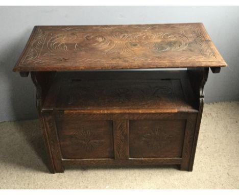 A Victorian carved oak monks bench