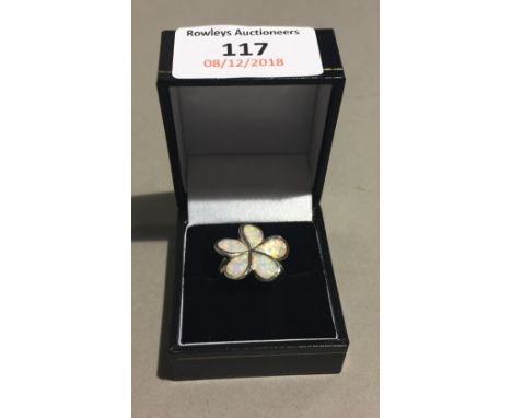 A silver and opal clover ring