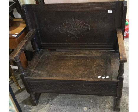 A carved oak monk's bench