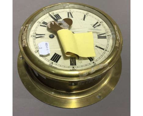 A bulk head clock, together with a wooden cased marine compass and two others