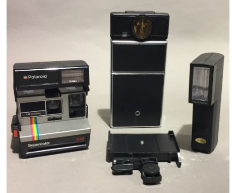 Two polaroid cameras and a flash