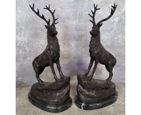 After Jules Moigniez, a pair of bronze stags standing on rocky outcrop, raised on a marble base, signed J. Moigniez 43cms hig