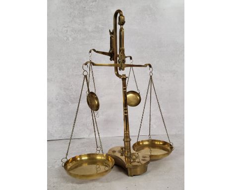 A late Victorian brass double beam weighing scales base holding 8 weights, (AF) 39cm heigh x 30cm wide x 13cm deep 