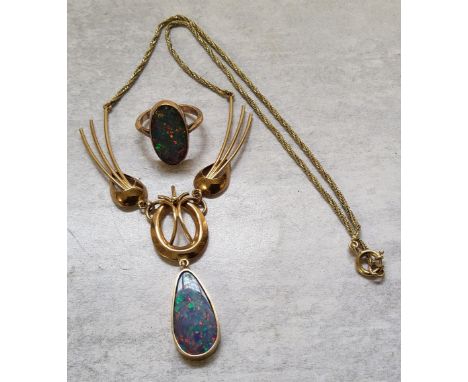 A 14ct gold opal ring set with an oval opal 3.05g gross; a contemporary yelow metal Y-drop necklace the pendant set with a Pe