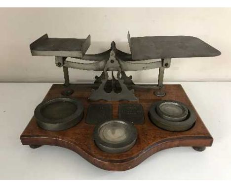 A set of antique postal scales with weights 