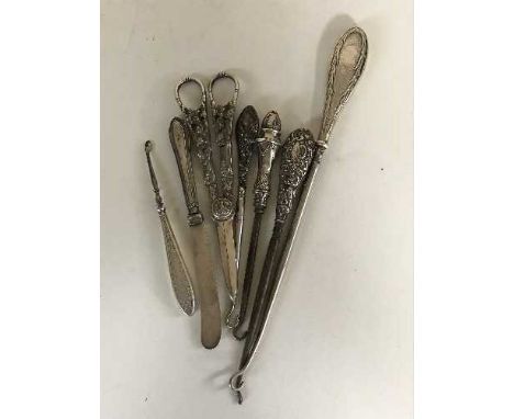 Four silver handled button hooks, scissors, silver handled knife etc 