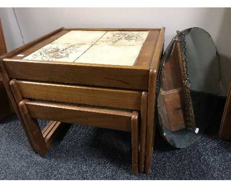 A nest of teak tables and an un-framed mirror 