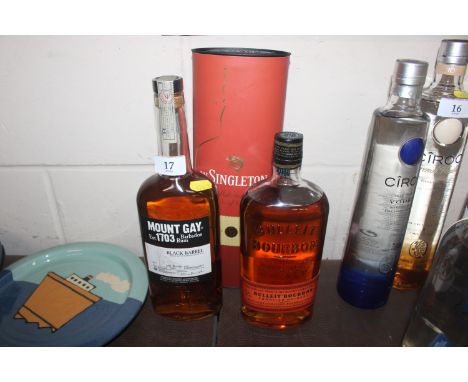 A bottle of Mountgay Black Barrel Rum; Bourbon Frontier Whisky and a boxed bottle of The Singleton single malt Scotch Whisky