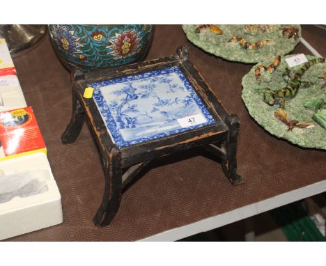 An antique stand with inset of blue and white tile AF