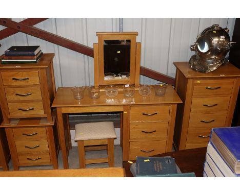 A light oak dressing table with fitted three drawers with dressing table stool and swing framed mirror 