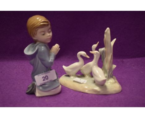 Two Lladro Nao figurines one of boy in prayer the other of three geese.AF.