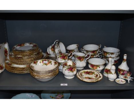 A selection of Royal Albert country roses, including plates,bowls,preserve pot, cups and saucers and more,around fifty eight 