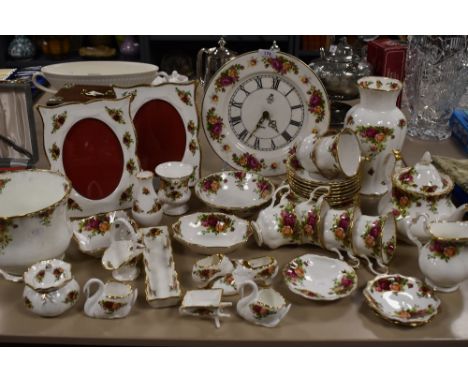 A varied lot of Royal Albert old country roses amongst which are planters, photo frames, cups and saucers and much more, also