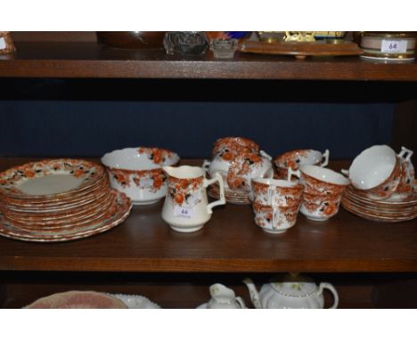 A collection of Wellington china having transfer pattern in russet tones with hand tinted floral and gilt detailing included 