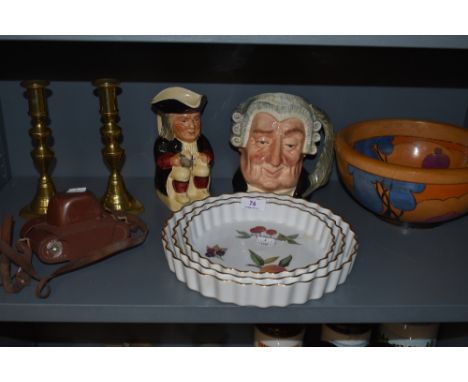 A mixed lot including Royal Worcester Evesham flan dishes,a pair of brass candle sticks,character jugs, art deco style wooden