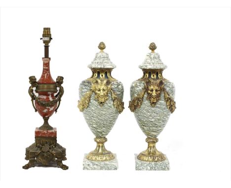 A pair of neoclassical-style veined marble cassolettes, each with gilt metal mask and swag decoration, 41cm high, together wi