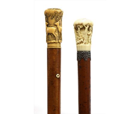 A carved ivory-handled walking stick, late 19th century, decorated with three stags in a wood, initialled to the top and set 