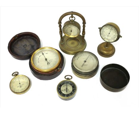 Six pocket aneroid barometers, the first by Negretti &amp; Zambra, London No.11,730, the second unnamed, in brass hanging sta