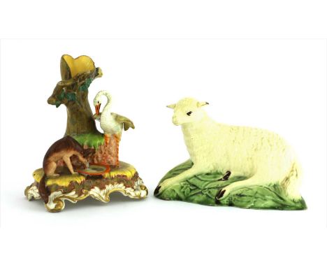 A Ralph Wood creamware sheep, c.1785, the recumbent animal as a grassy mound, 16cm long, and a Staffordshire pottery spill va