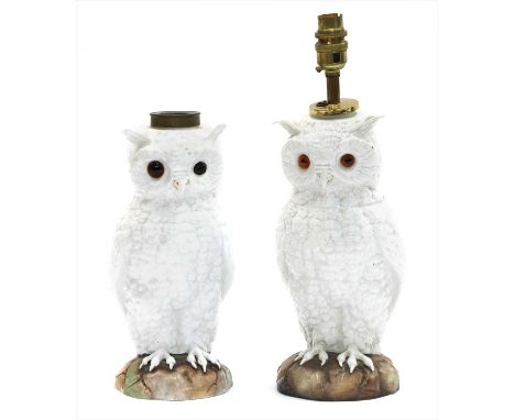 A pair of pottery owl table lamp bases, mid-19th century, German, each as a standing bird on a circular stump, one fitted for