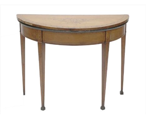 A George III inlaid satinwood demilune fold-over card table, the top inlaid with an oval patera within a scrolled garland and