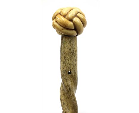 A carved marine ivory walking stick , 19th century, the knot handle on a tapering twist turned shaft, 89.5cm long