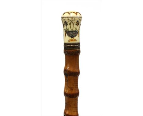 An ivory and piqué walking stick, early 18th century, the handle finely inlaid with two vases of flowers, now on a cane shaft