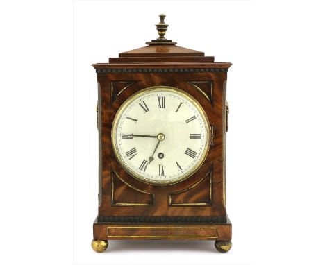 A Regency mahogany mantel clock, the white dial painted dial with black Roman numerals, behind a convex glass, with cornucopi