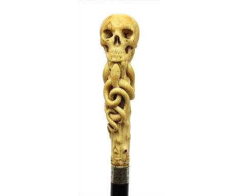 A carved ivory skull and snake walking stick, late 19th century, with metal mount inscribed 'E. Brandt s/C.A. Marben z. Fr. E