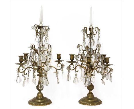 A pair of five-light cut-glass and brass table lustres, 19th century, each with multiple branches hung with shaped cut-glass 