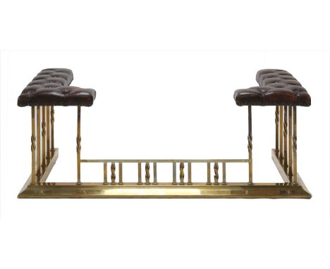 A brass and leather club fender, early 20th century, the button upholstered top with brass twist supports, external 136cm wid