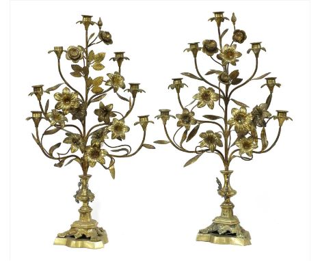 A pair of Continental floral gilt metal candlestick stands, 20th century, seven lights amongst flower heads and leaves, on co