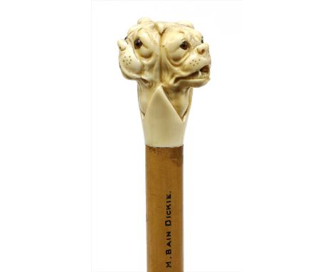 A carved ivory triple bulldog's head walking stick , late 19th century, by Brigg, each head with glass eyes, the shaft inscri