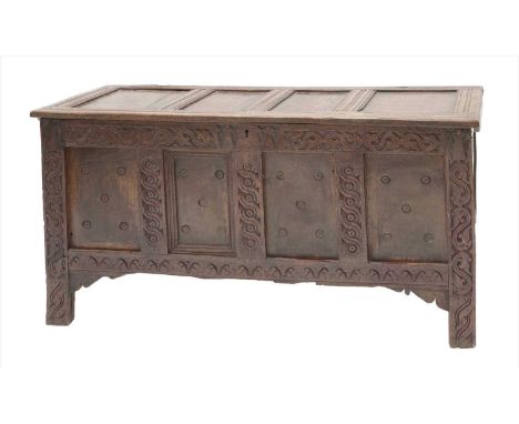 An oak four-panel coffer, basically 17th century, the rectangular top with split-pin hinges, enclosing the interior with a ca