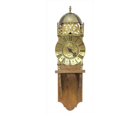 A brass lantern clock , early 18th century and later, with a strapped bell, anchor escapement and central foliate engraving, 