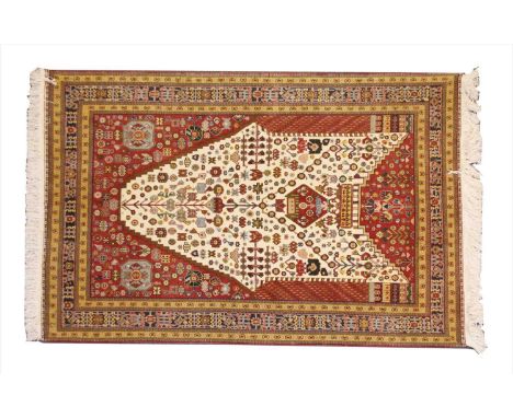 A Persian Qashqai prayer rug , 20th century, the shaped central panel woven with repeating geometric floral and foliate motif